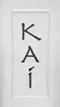 A tall white sign with the word " kai " written in black letters.